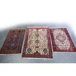 three small oriental rugs || Lot van drie kleine Oosterse tapijten : een Afghaanse Beloutch en