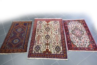three small oriental rugs || Lot van drie kleine Oosterse tapijten : een Afghaanse Beloutch en