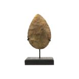 Presumably prehistoric two-sided axe head with typical characteristics of the Mousterian, named