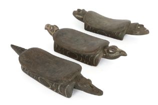 three Papua New Guinean Middle Sepik headrests in wood with sculpted animal heads || PAPOEASIE NIEUW