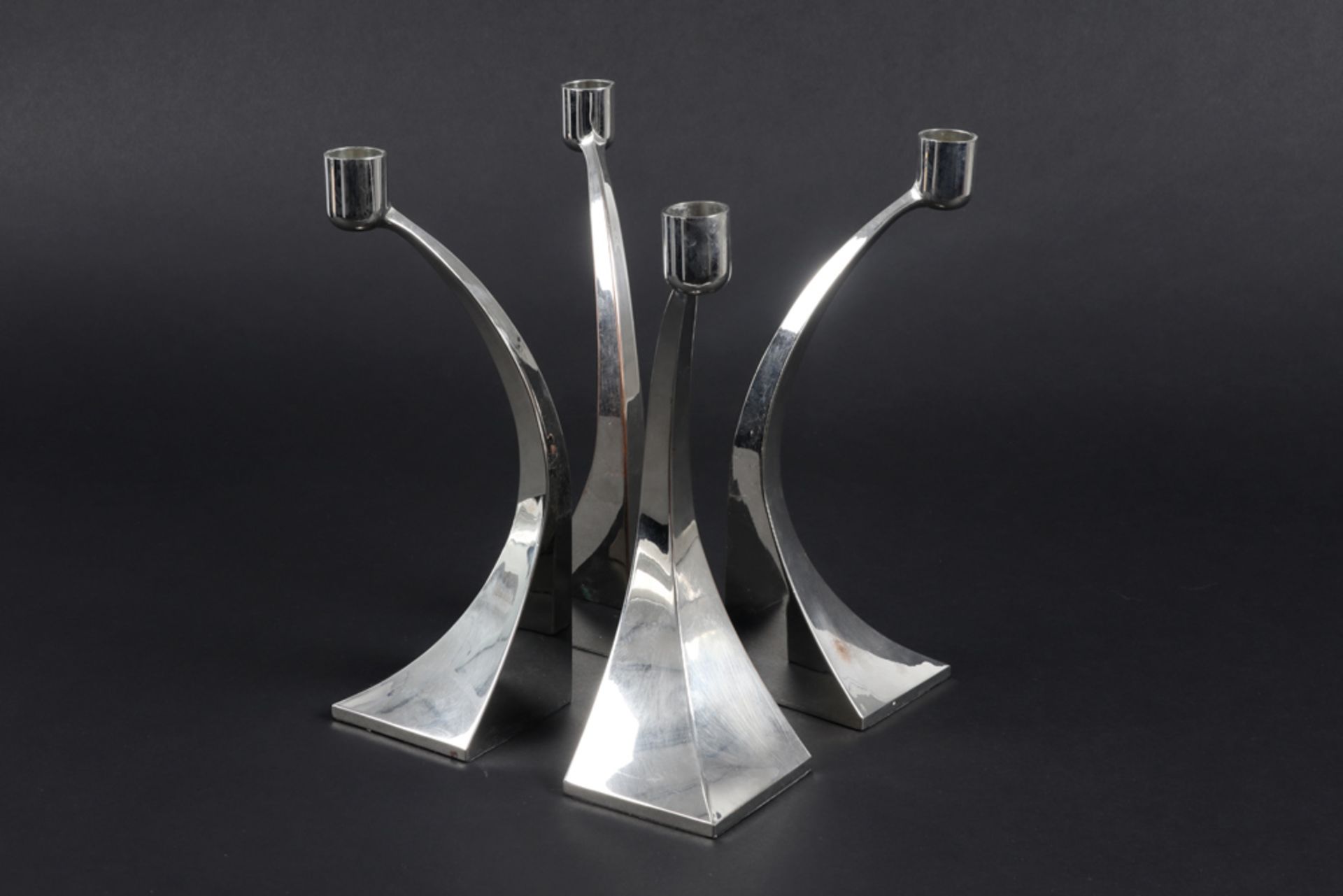 series of four Italian fifties'/sixties candlesticks in chromed brass || Reeks van vier Italiaanse