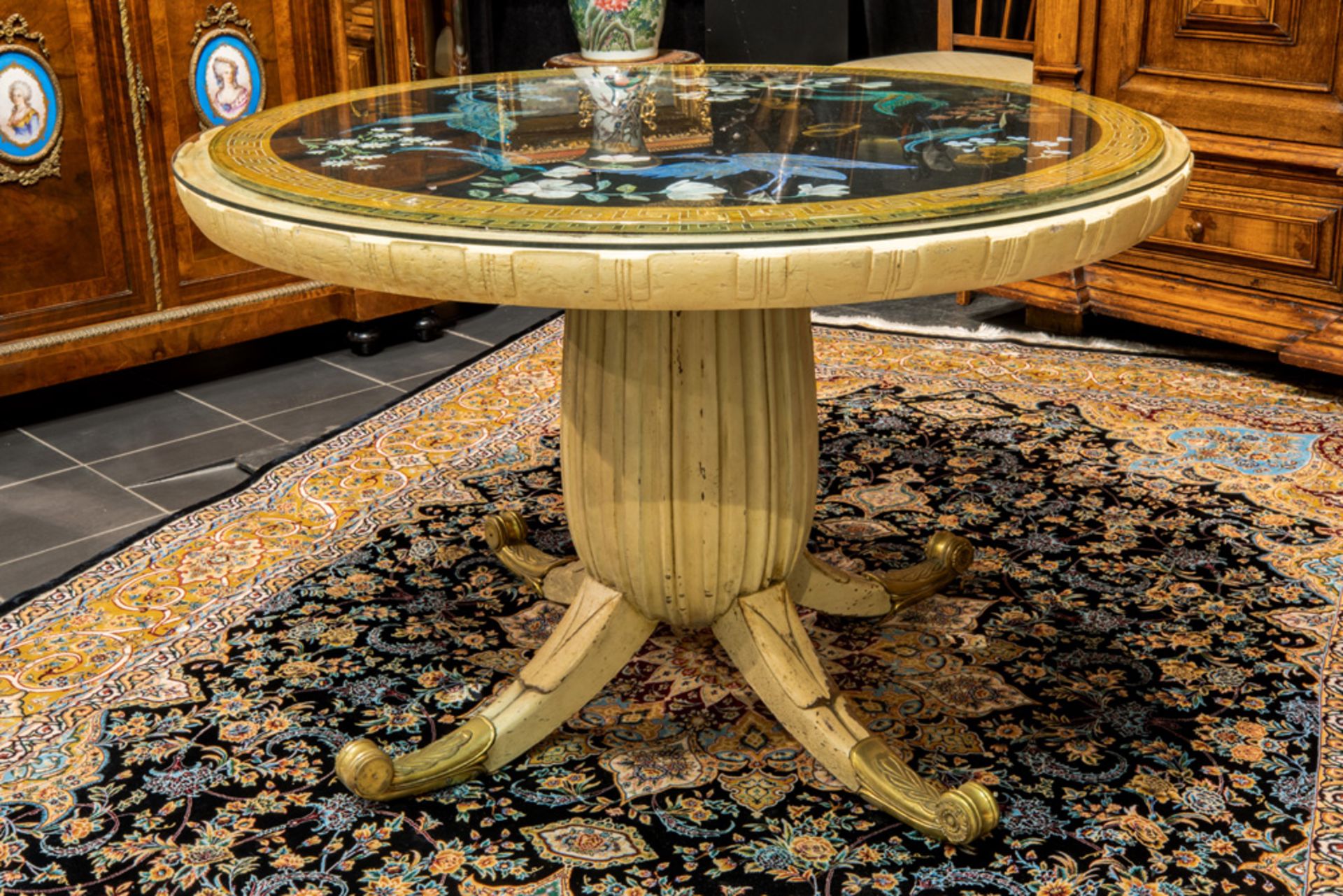 quite special, presumably Italian Art Deco table in painted wood and gilded bronze with a round