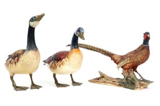three sculptures : a porcelain pheasant and a couple of ducks with bronze feet marked "Elli