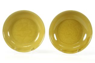 pair of antique Chinese "Imperial yellow" plates in marked porcelain with an underlying decor with