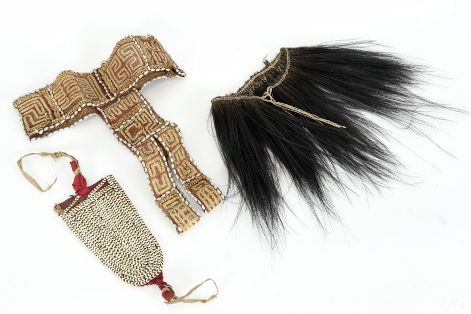 three Papua New Guinean garment ornamentations, amongst which a Sepik and a Wamena one ||