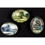 three oval brooches each with a plaque in mother of pearl/shell with a painted landscape || Lot