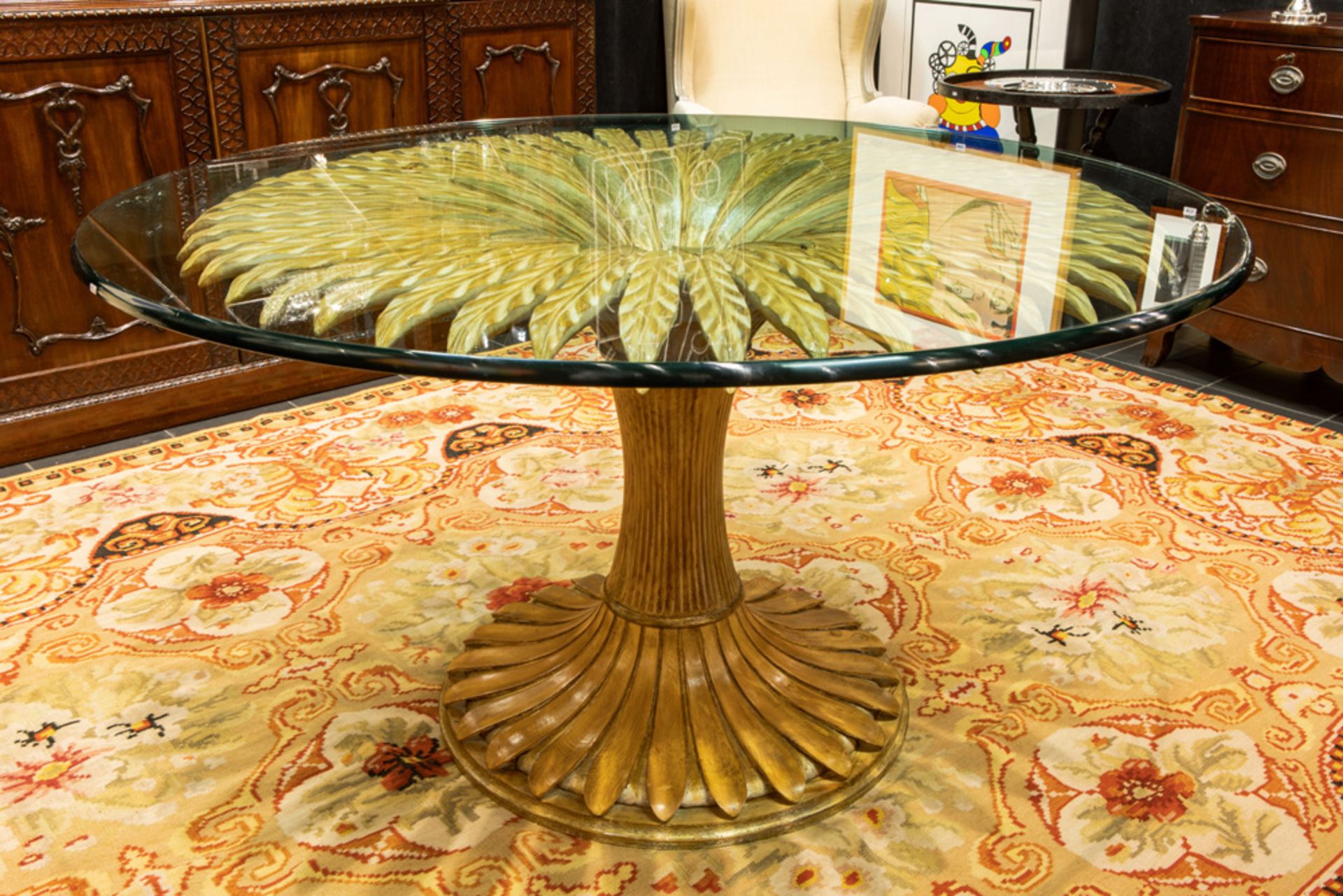 nineties' "Regency" design table with a base in partially gilded wood with typical leaves and with a