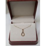0.09CT DIAMOND TWIST PENDANT /9CT YELLOW GOLD IN GIFT BOX WITH VALUATION CERTIFICATE OF £895