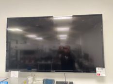 Finlux Smart television with remote (wall mounted, model unknown, approx 42”)