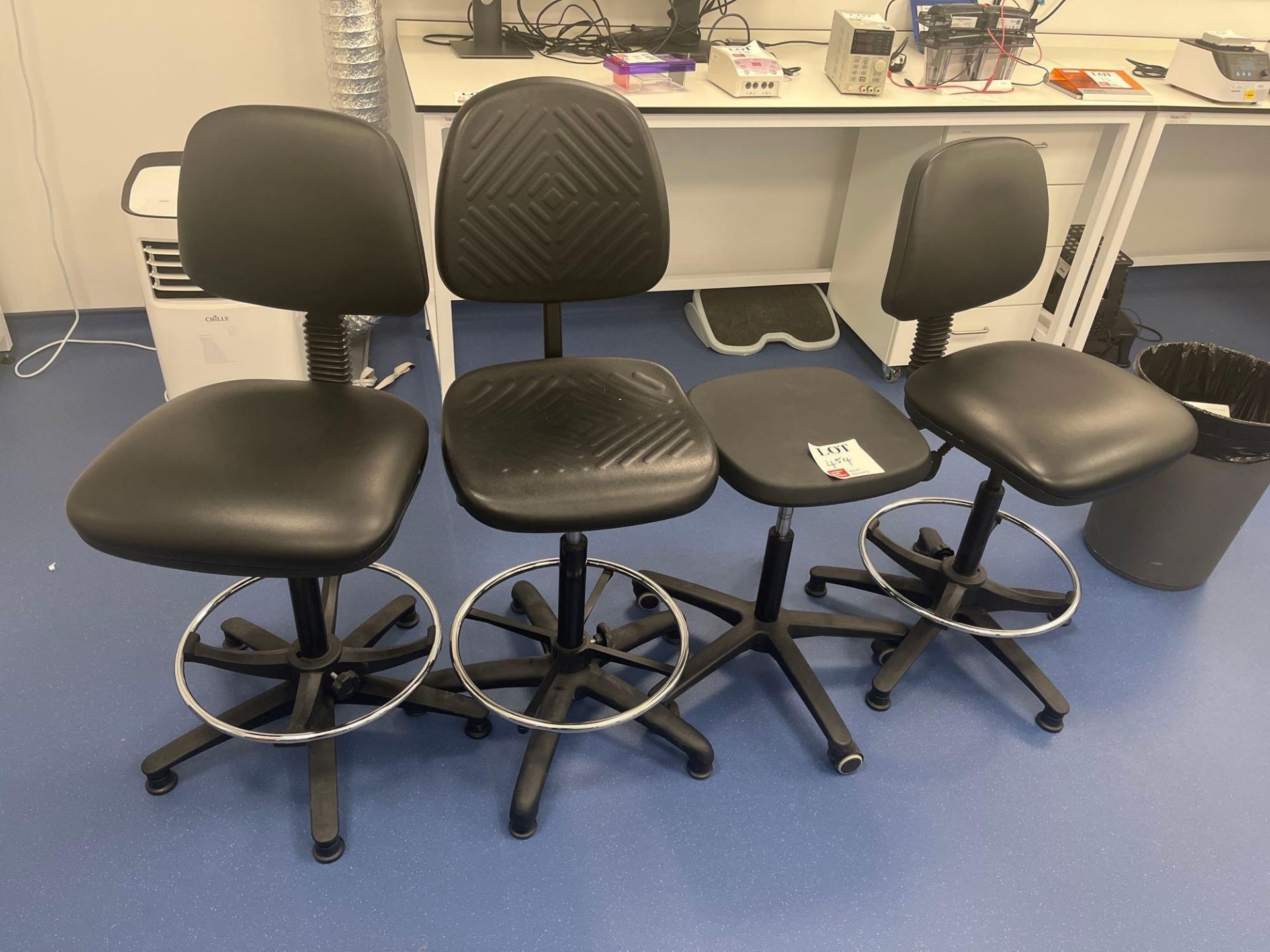 Three various black chairs and a black stool