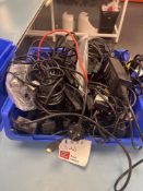 Contents of container comprising quantity of various laptop charges and cables
