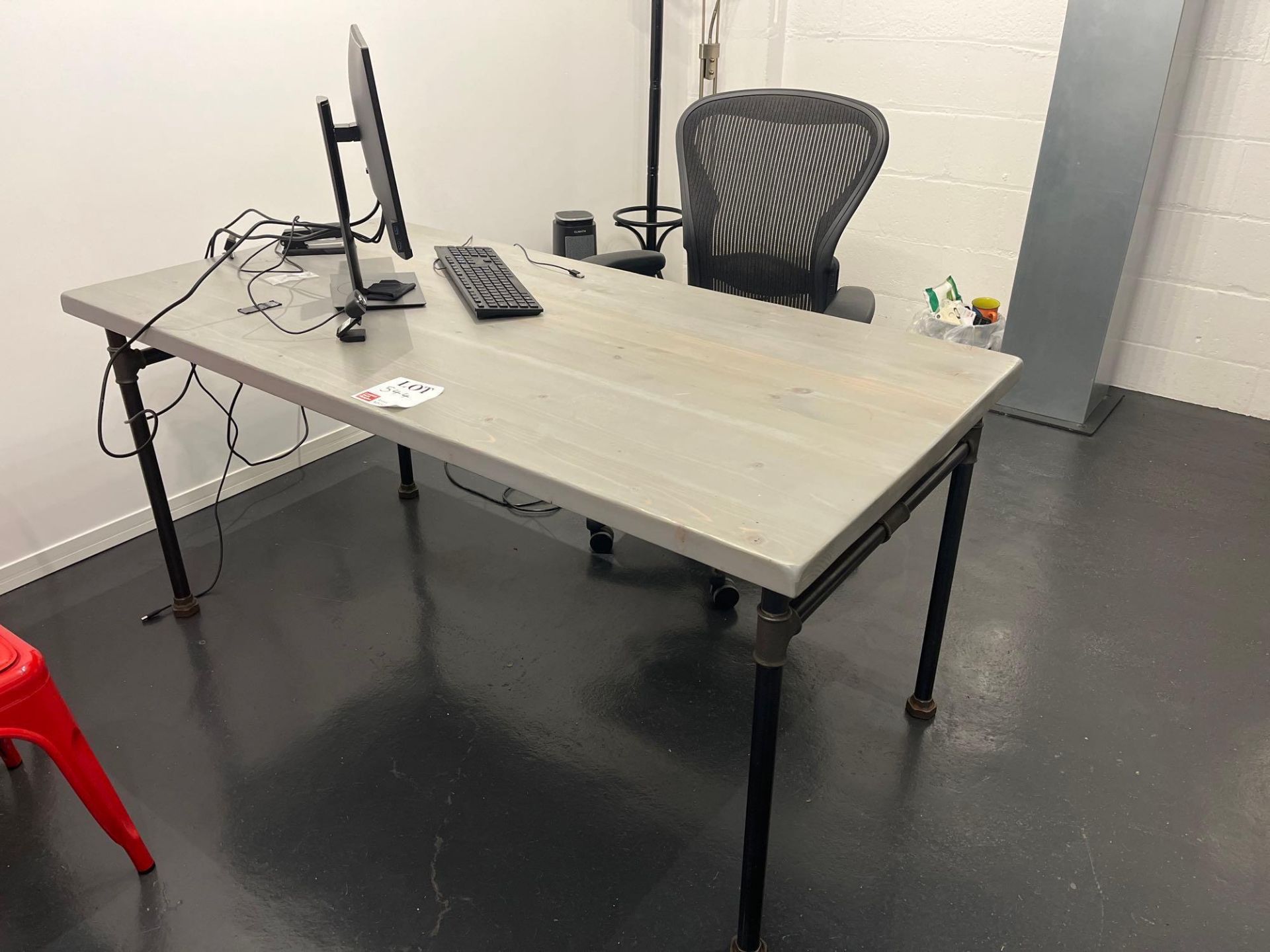 Bespoke industrial style wood top table with Dell P2419H monitor and black mesh back operator chair