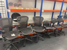 Three black mesh back operator chairs with three various black chairs