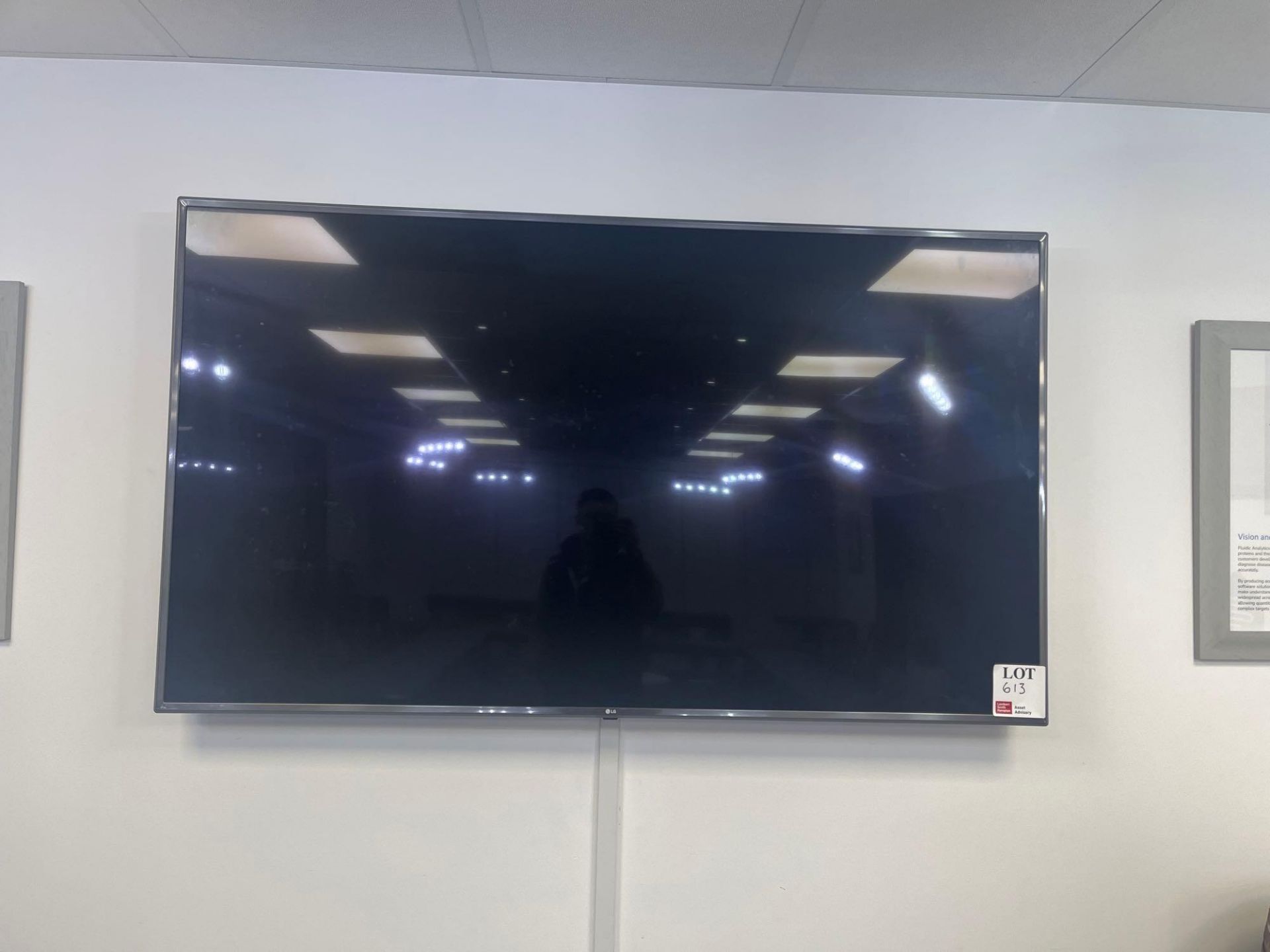 Wall mounted LG 72” smart television with remote (model unknown)