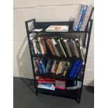 Four tier bookshelf with a quantity of various books