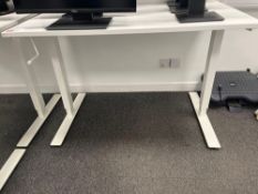 Three white adjustable height desks (excludes contents) (approximately 120cm L x 70cm W)