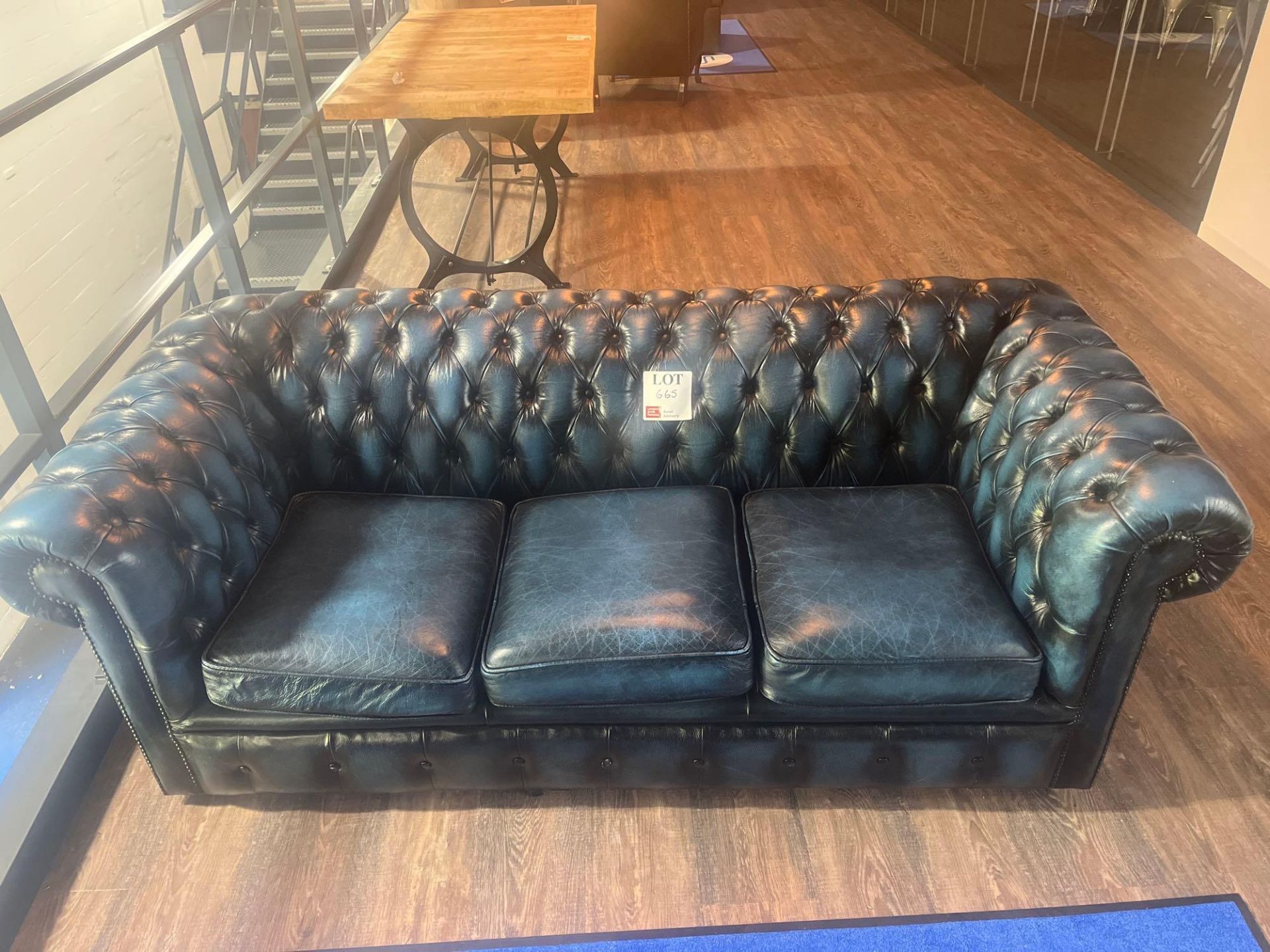 Chesterfield style blue leather upholstered three seater sofa