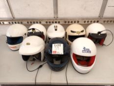 Eight various rally crash helmets