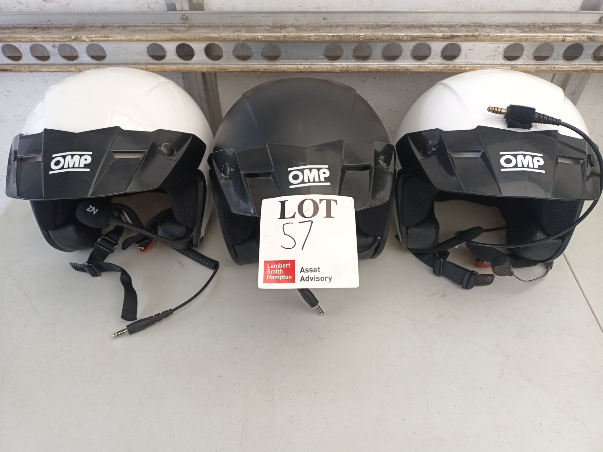 Three various OMP rally crash helmets