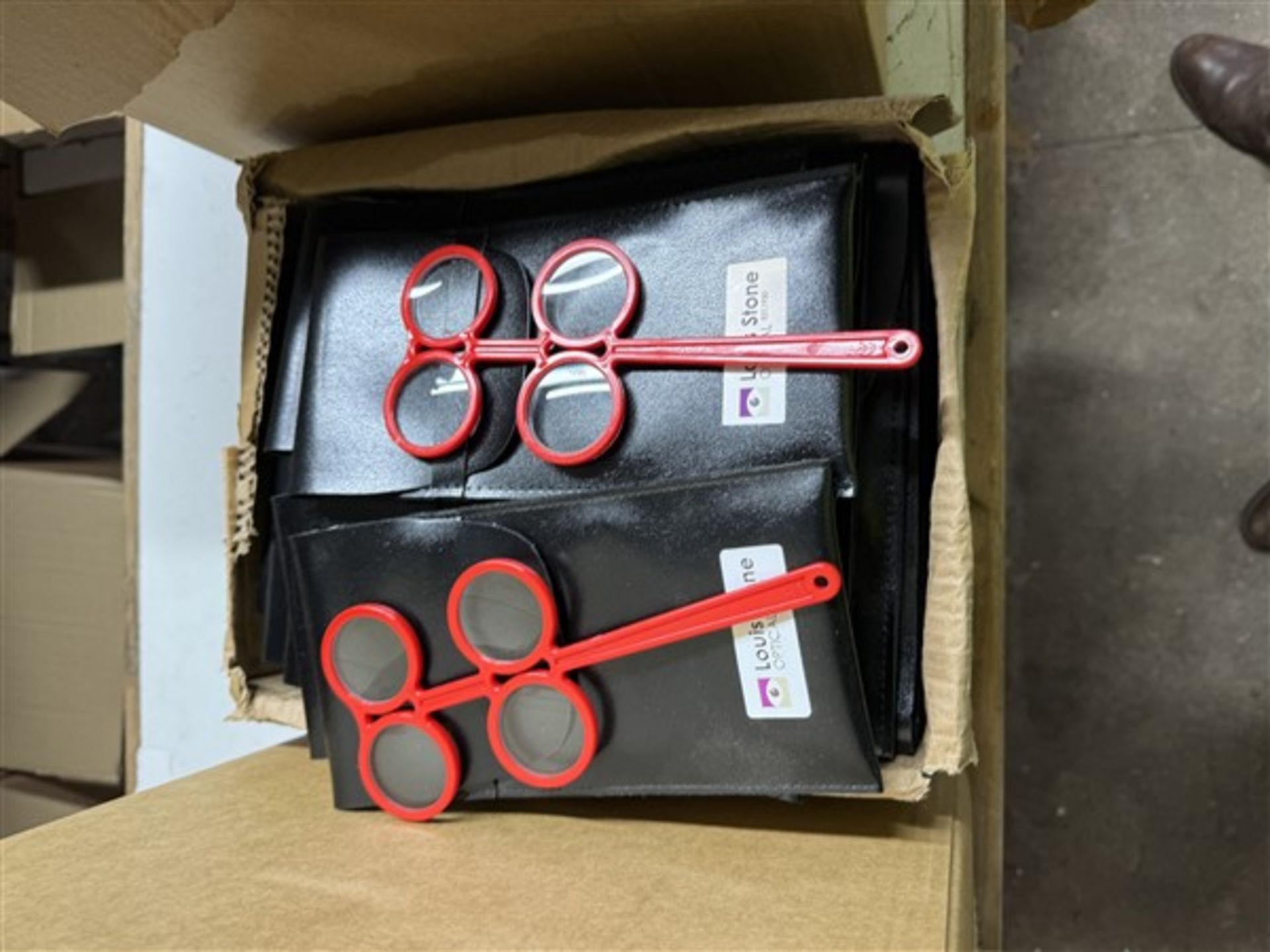 Box of individually packed plastic lens flippers