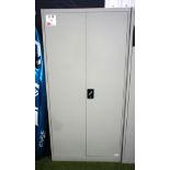 Metal double-door storage cabinet with contents