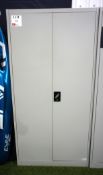Metal double-door storage cabinet with contents