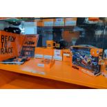 Contents of shelf of KTM Merchandise as pictured