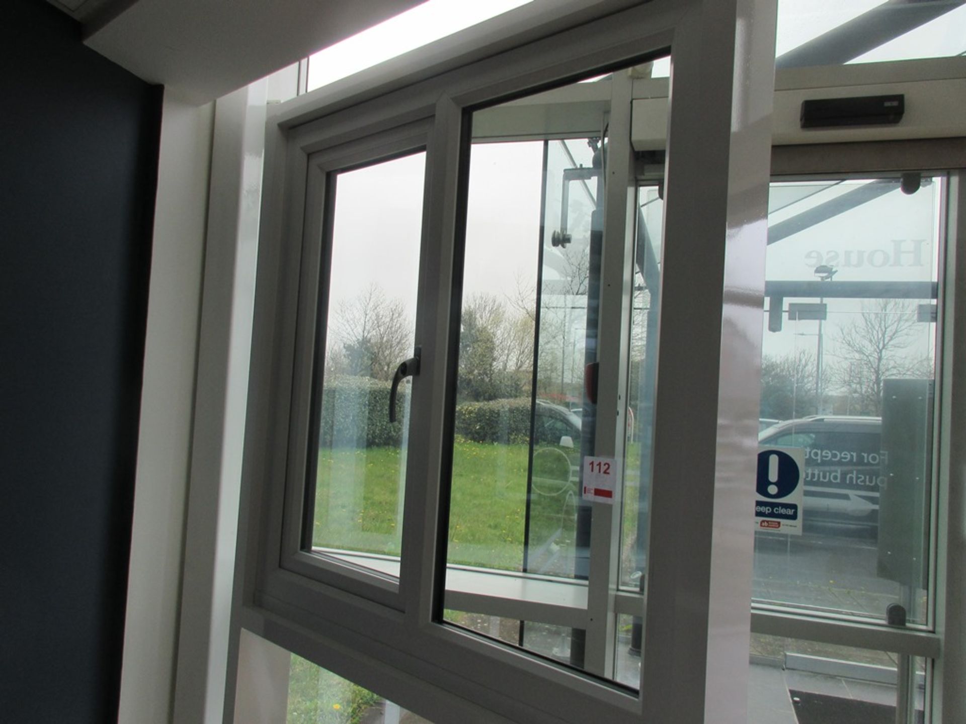 Aluminium framed single door showroom window