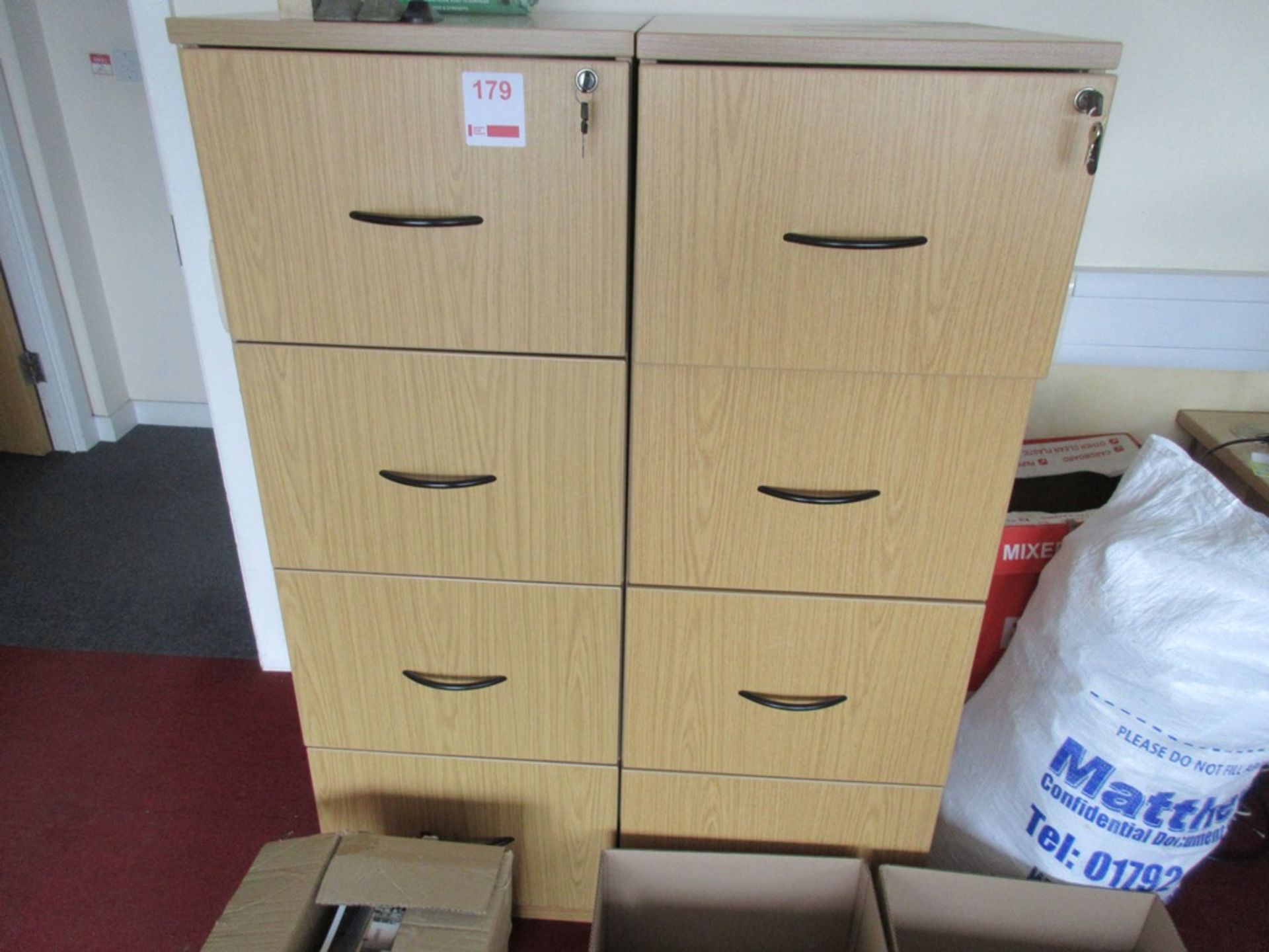 Two light wood 4-drawer filing cabinets