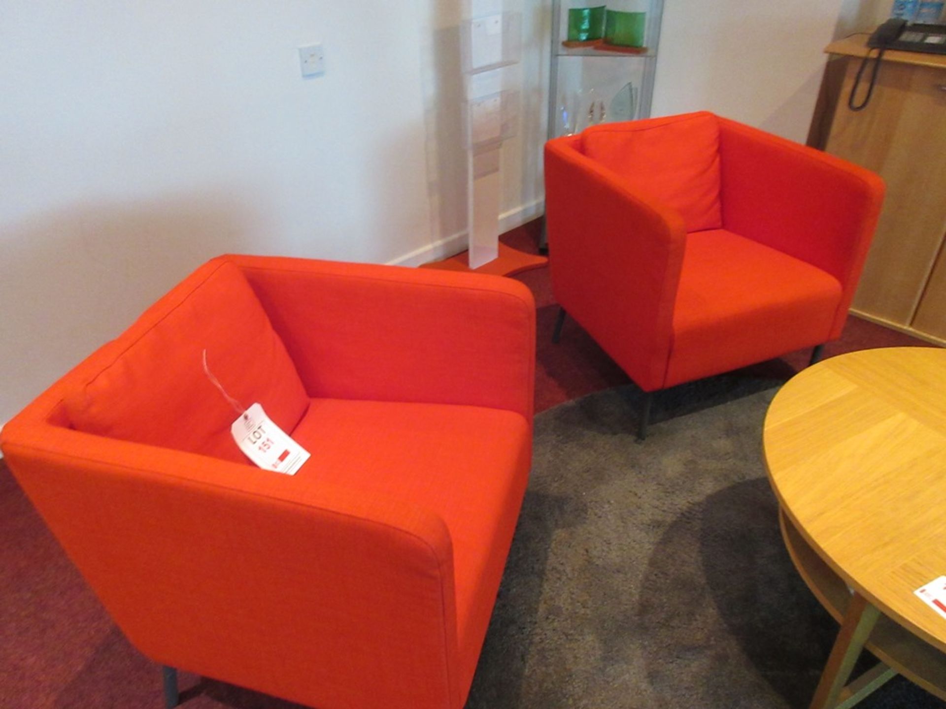 Two red cloth upholstered tub style armchairs