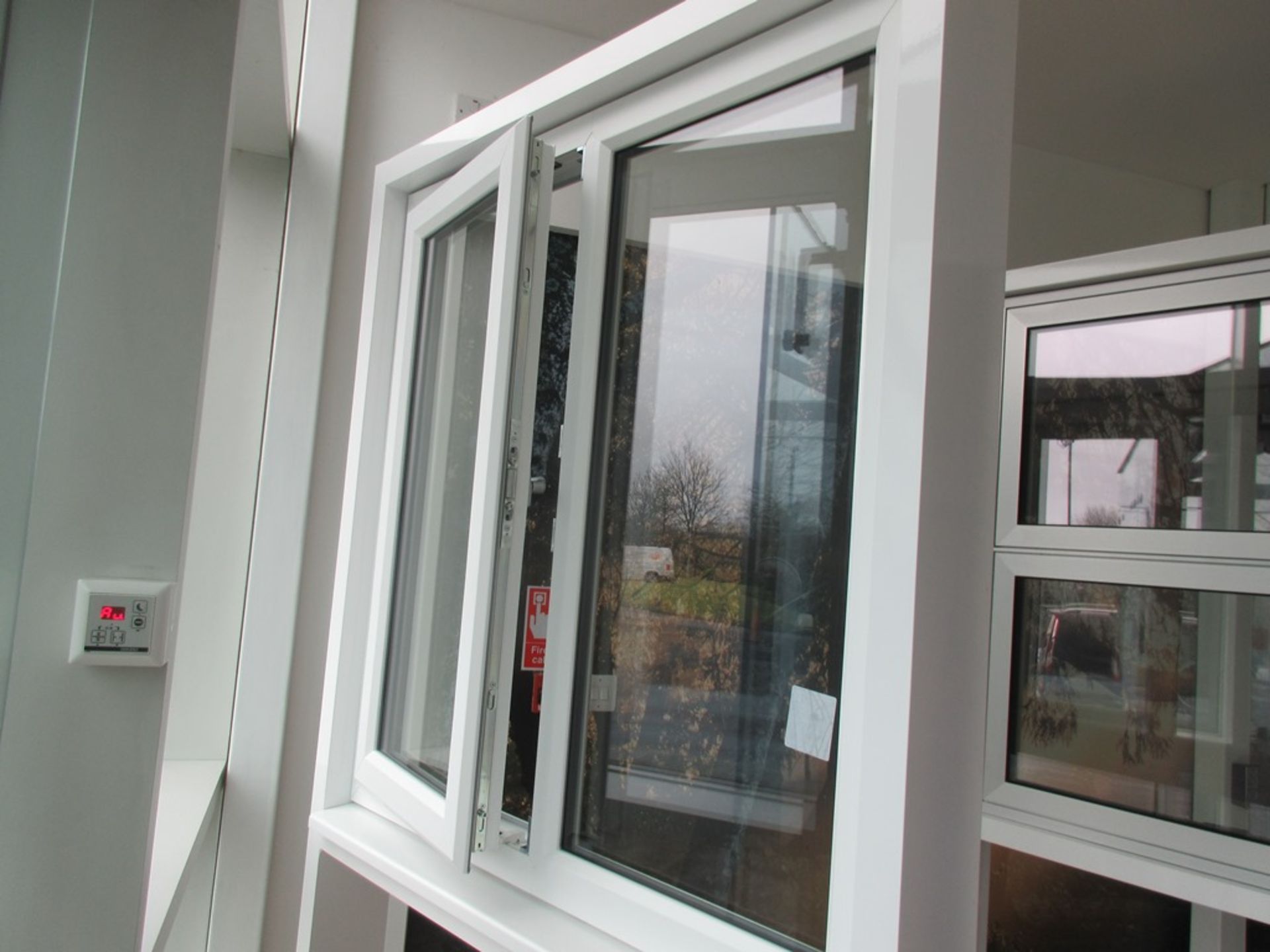 Aluminium framed single door showroom window