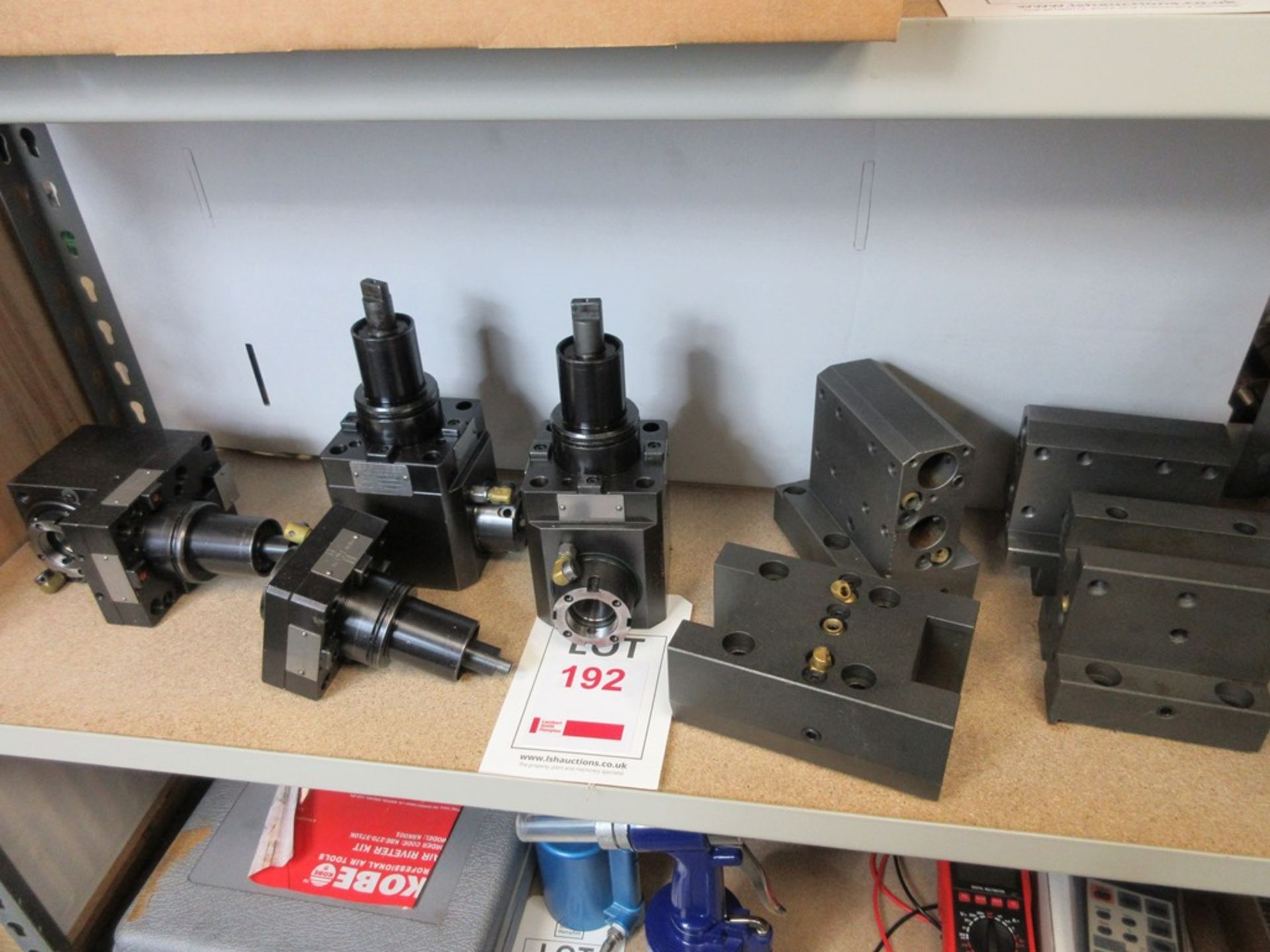Eight pieces of various tooling on one shelf