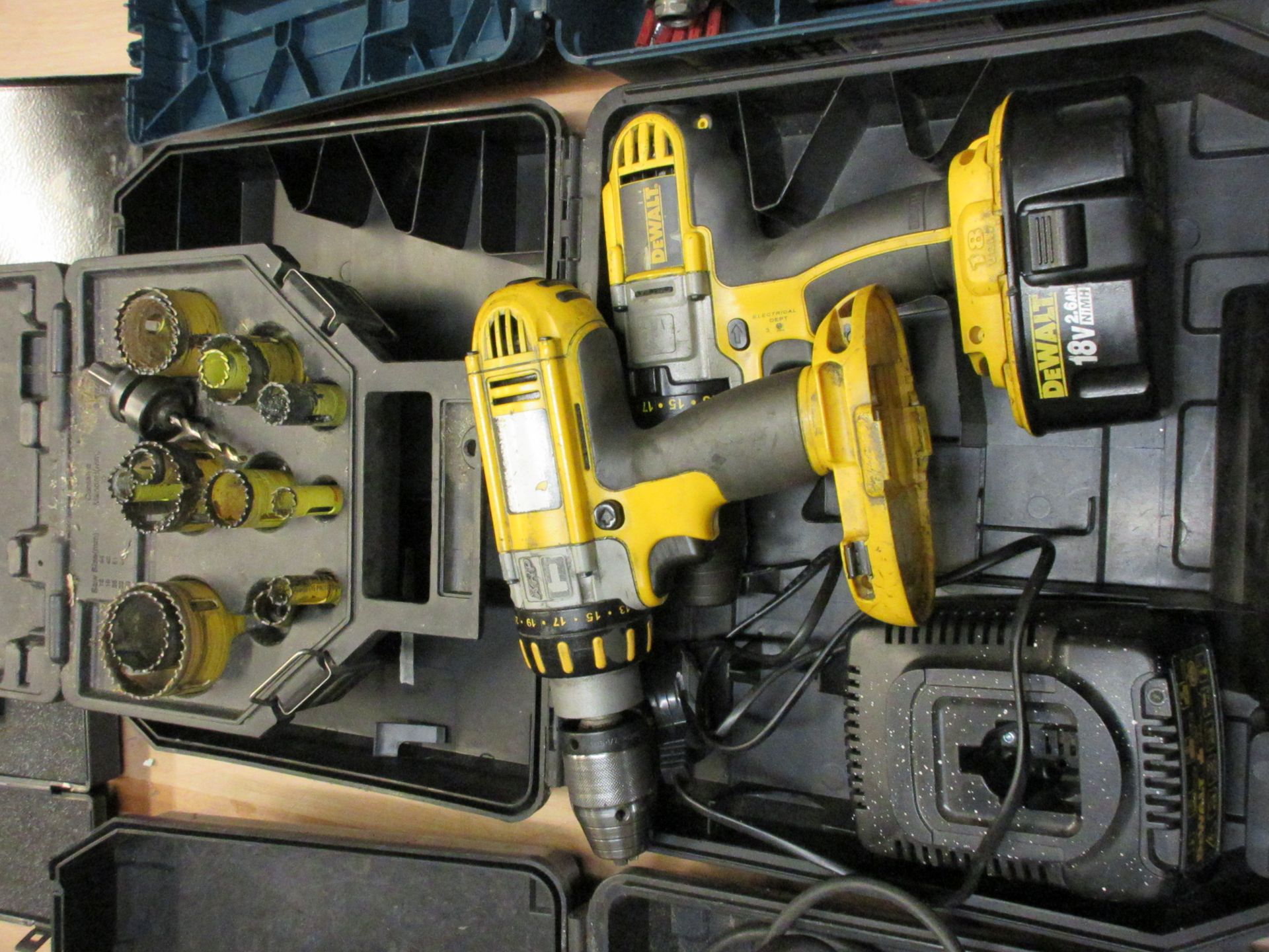 Two assorted Dewalt cordless combi drills, 18v, one charger, one battery and Dewalt hole saw set