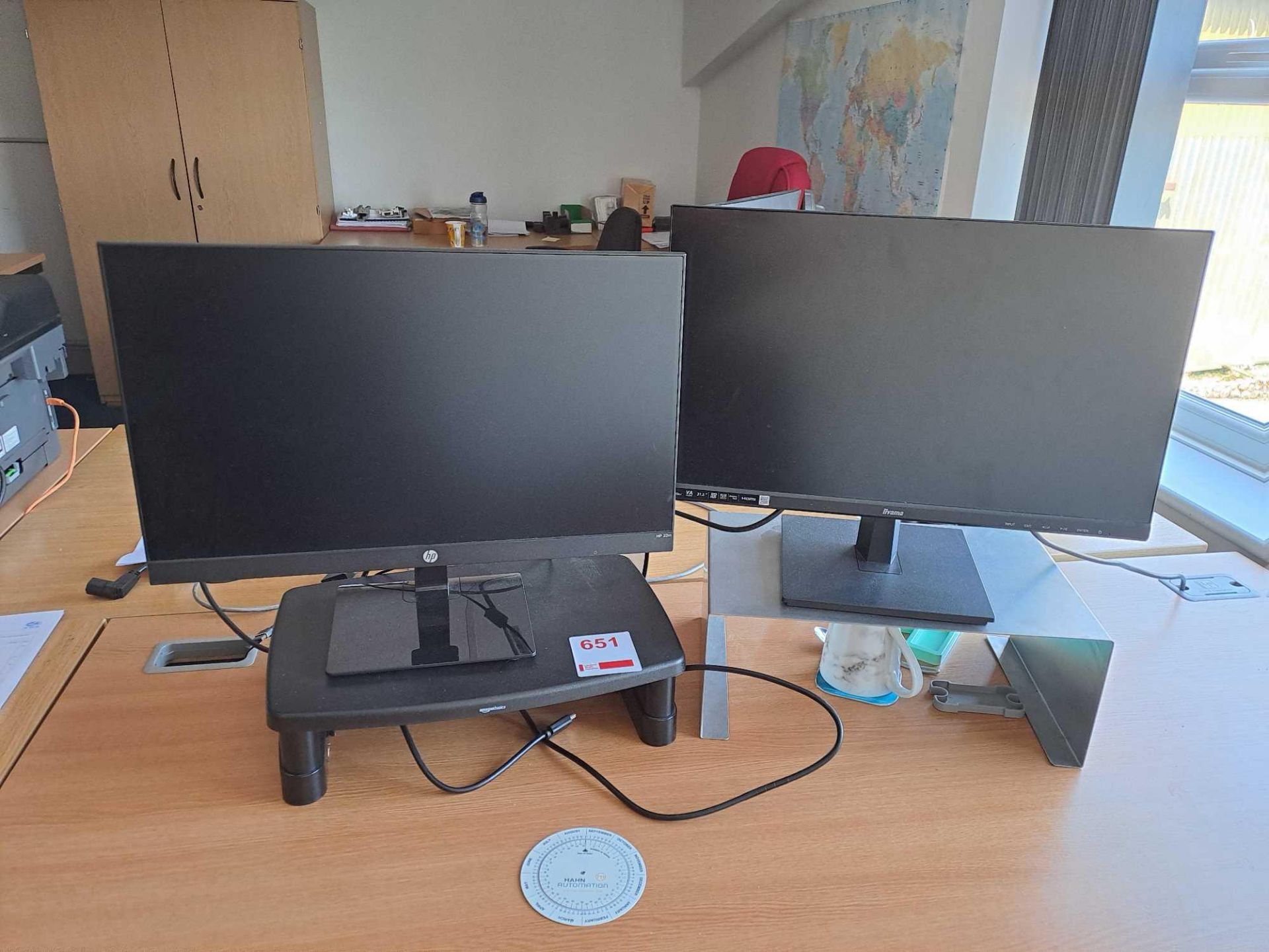 HP monitor and one Ilyama monitor, both with stands