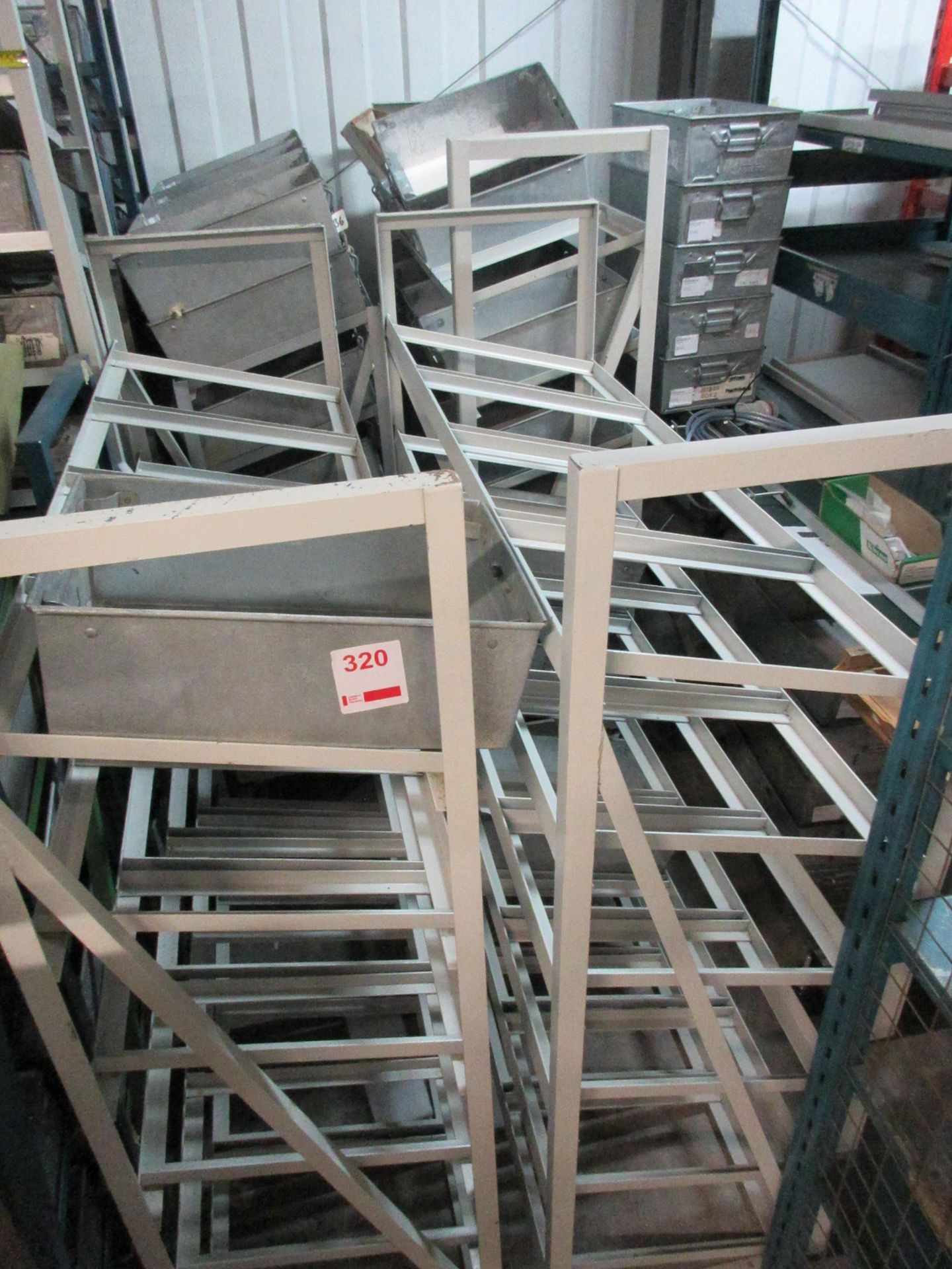Four metal frame single sided racks, 1300 x 450mm, with quantity of tote pans