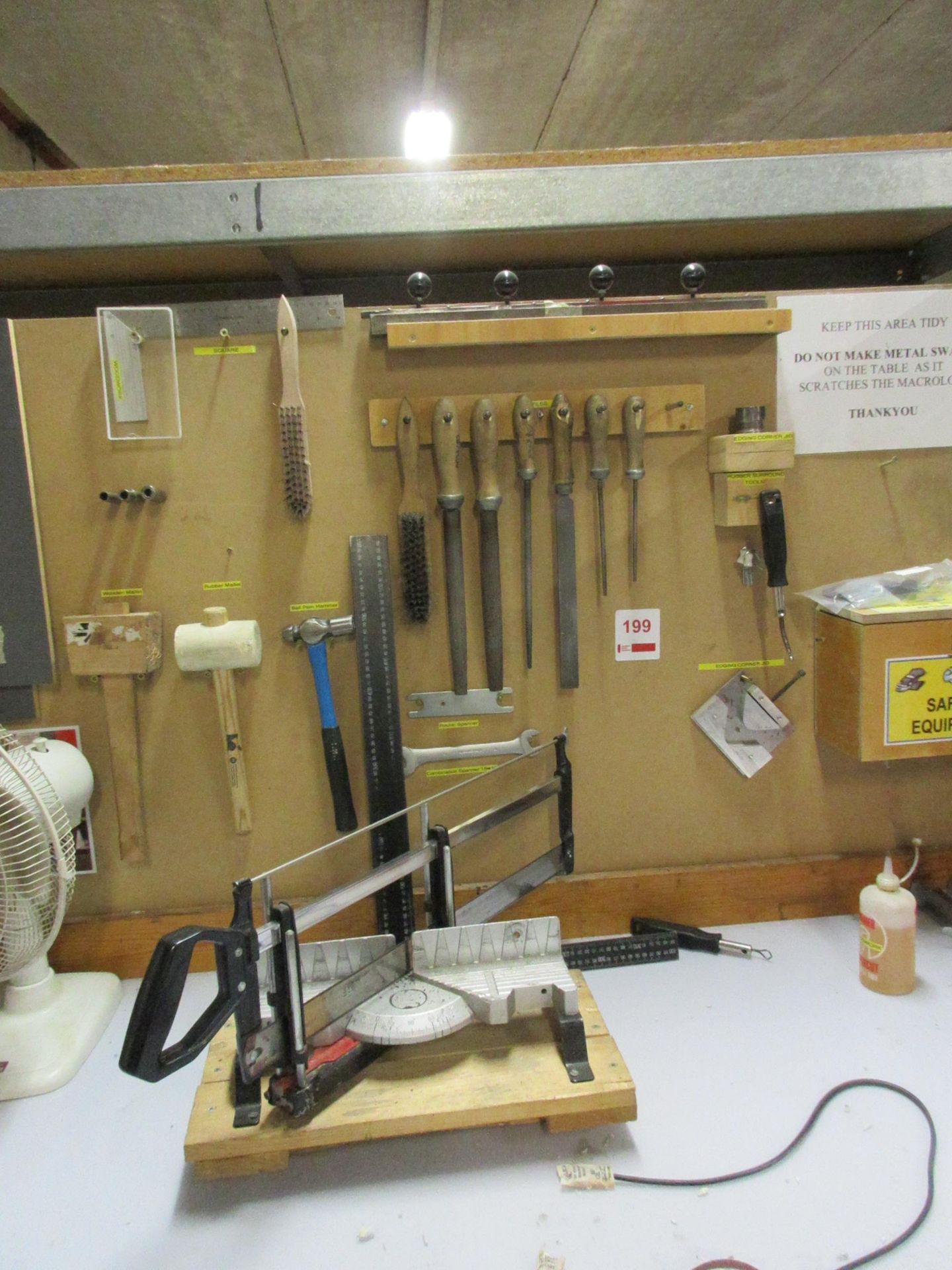 Assorted hand tools including files, hammer, mallet, square, wire baskets, mitre saw, Henry Xtra