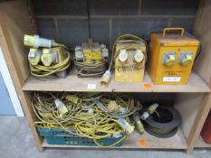 2x Shelves of Various 110V Items to include Cables, Splitter Boxes and a Transformer