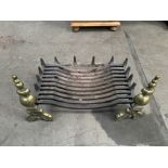 Cast iron fire grate supported on cast brass fire dogs