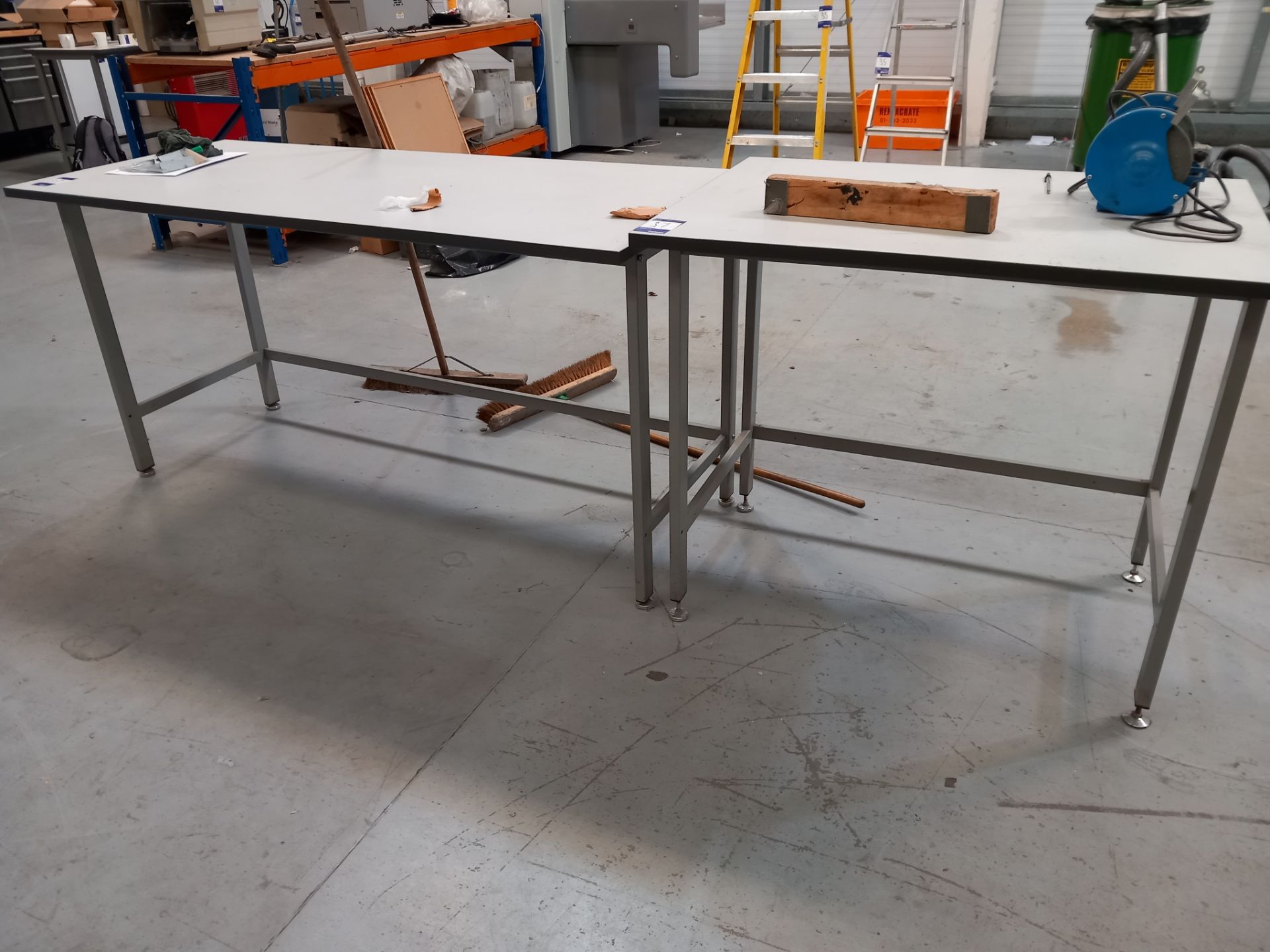 Two steel framed packing tables
