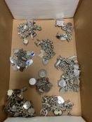 Various silver charm bracelets with assay stamps - together with a variety of charms - some stamped