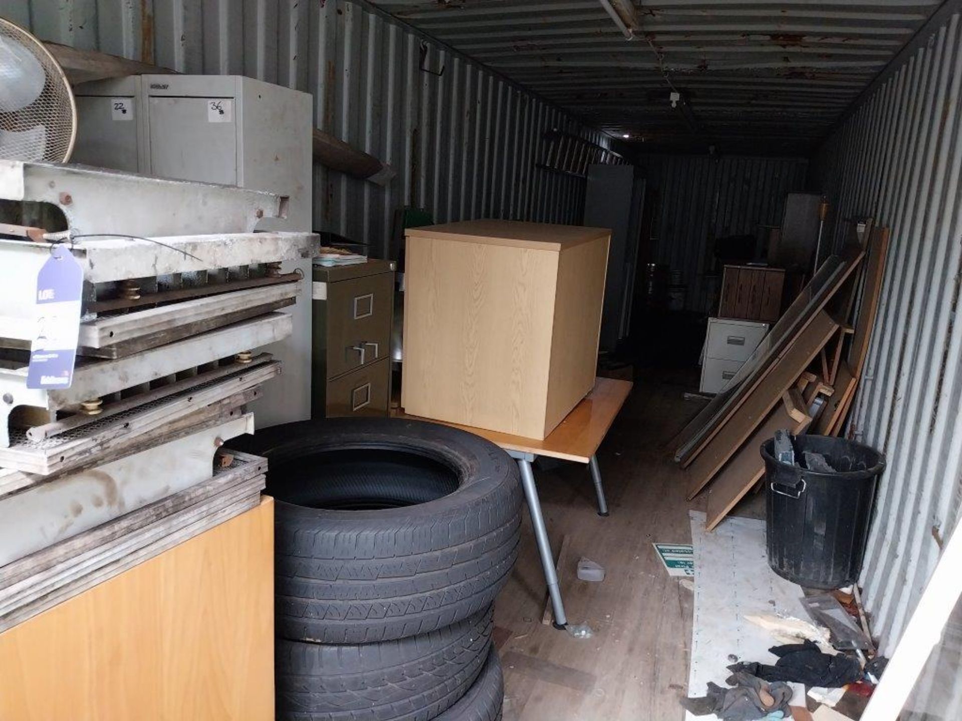 Remaining contents of container to include furniture, filing cabinets, tyres etc.