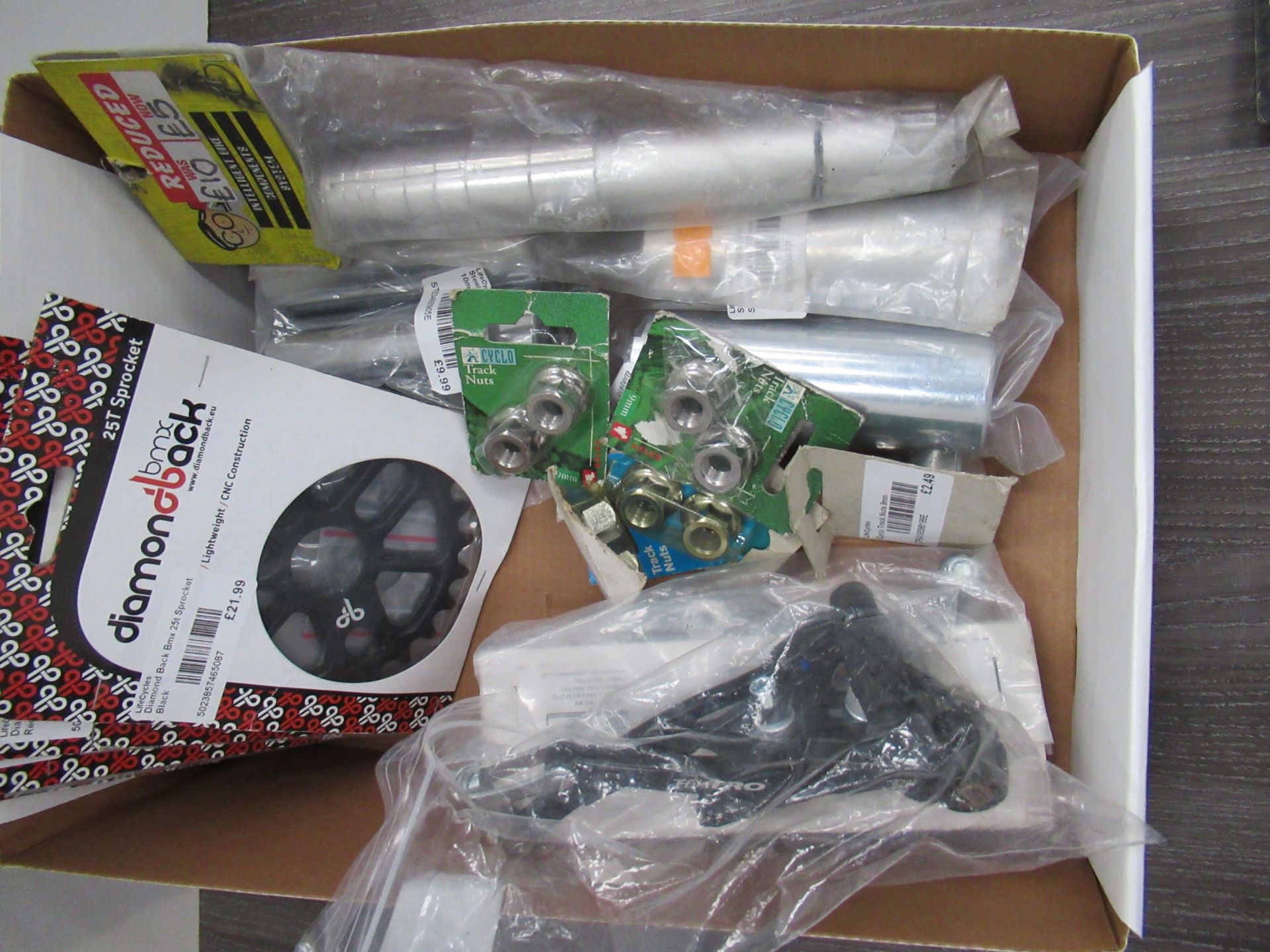 Box of cycling accessories to include stunt pegs; lock rings; BMX 25T sprockets etc. - Image 5 of 5