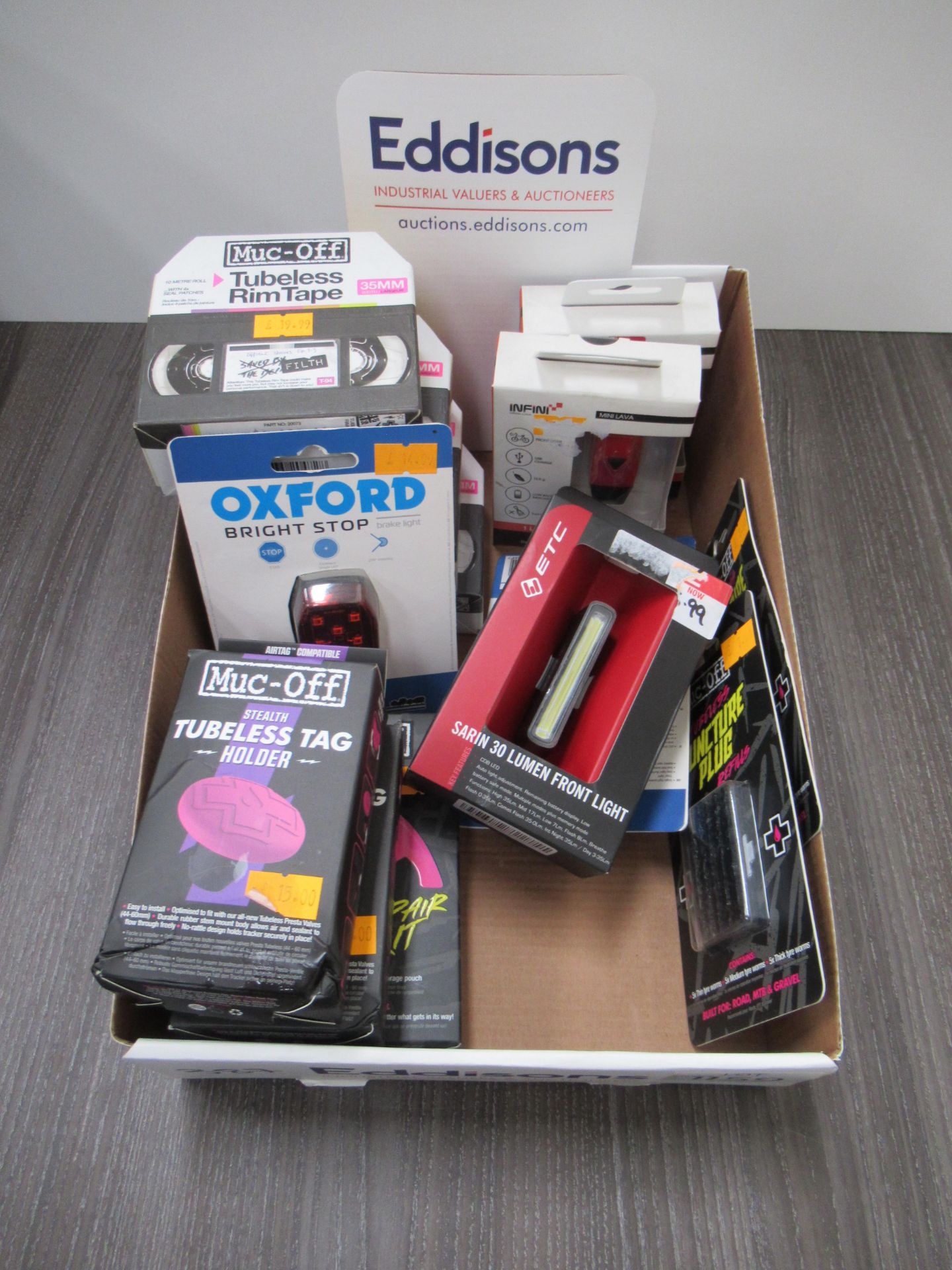 Contents of box to include Muc-Off tubeless rim tape, Muc-Off tubeless tags, Oxford brake lights, E