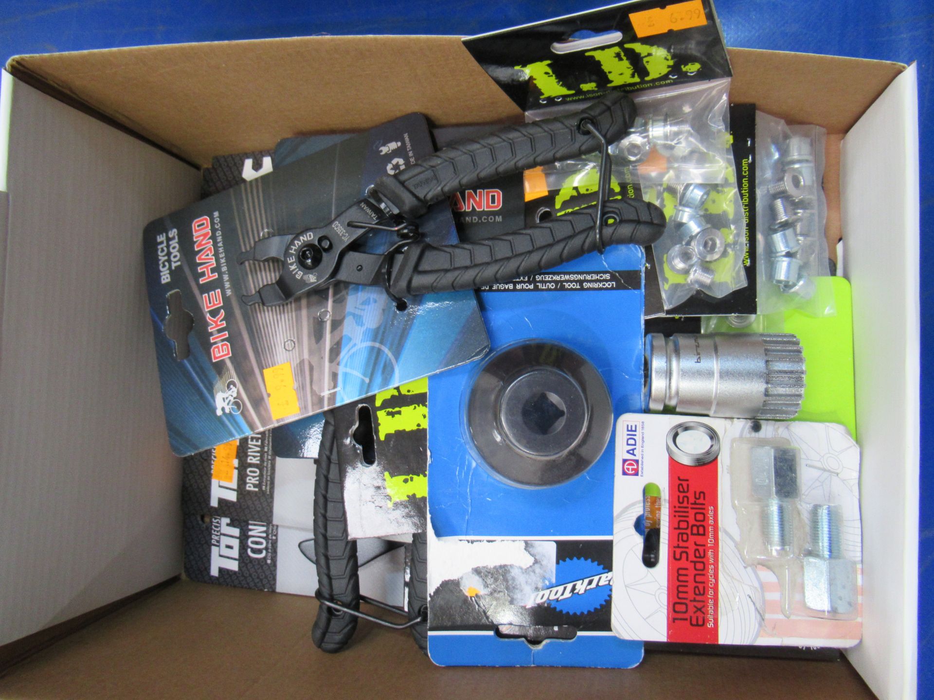 Box of assorted cycling tools and parts