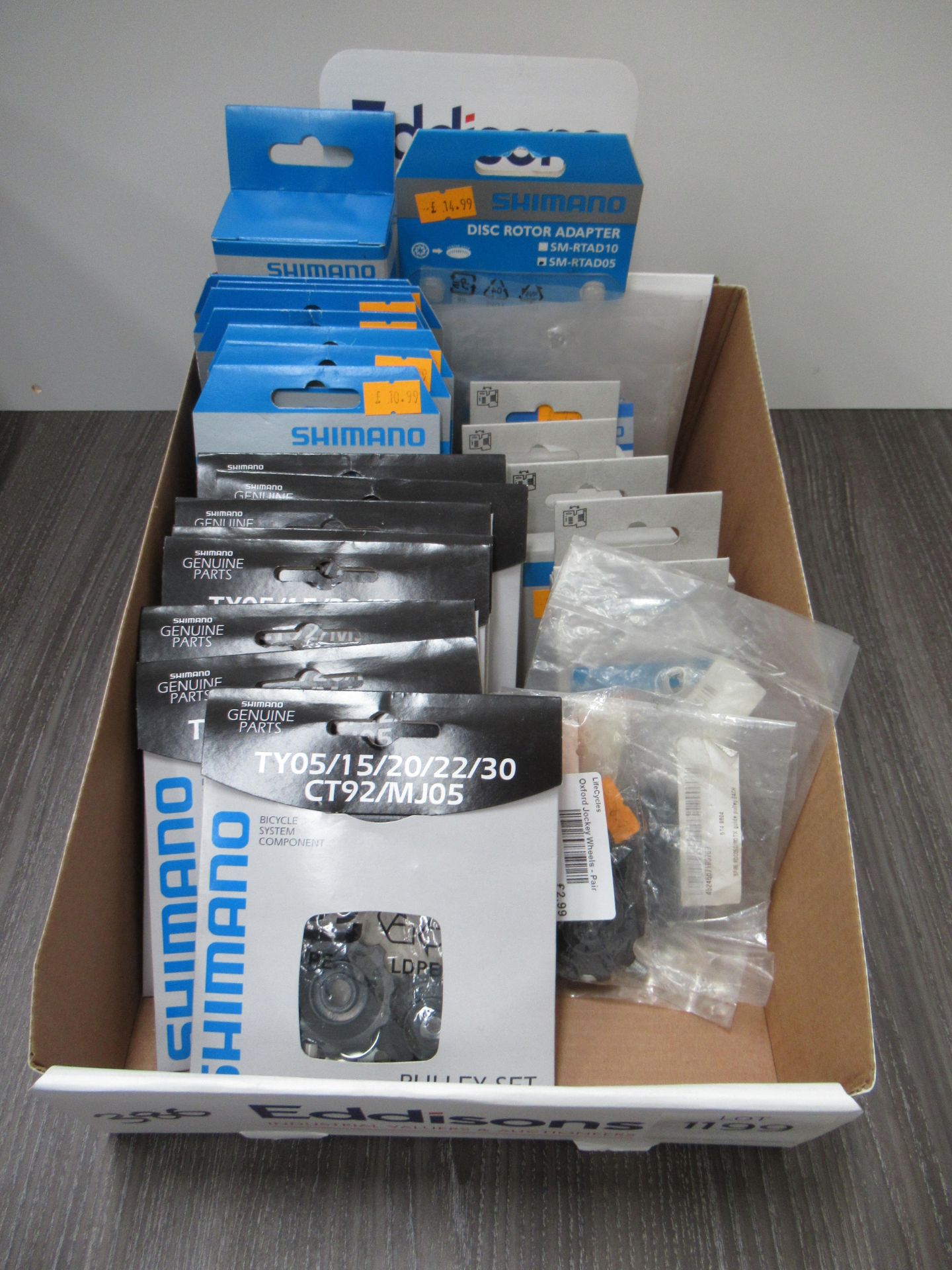 Box of Shimano cycling accessories to include RD-7000 pulley sets; RD-8000 pulley sets; Cleat Adapte