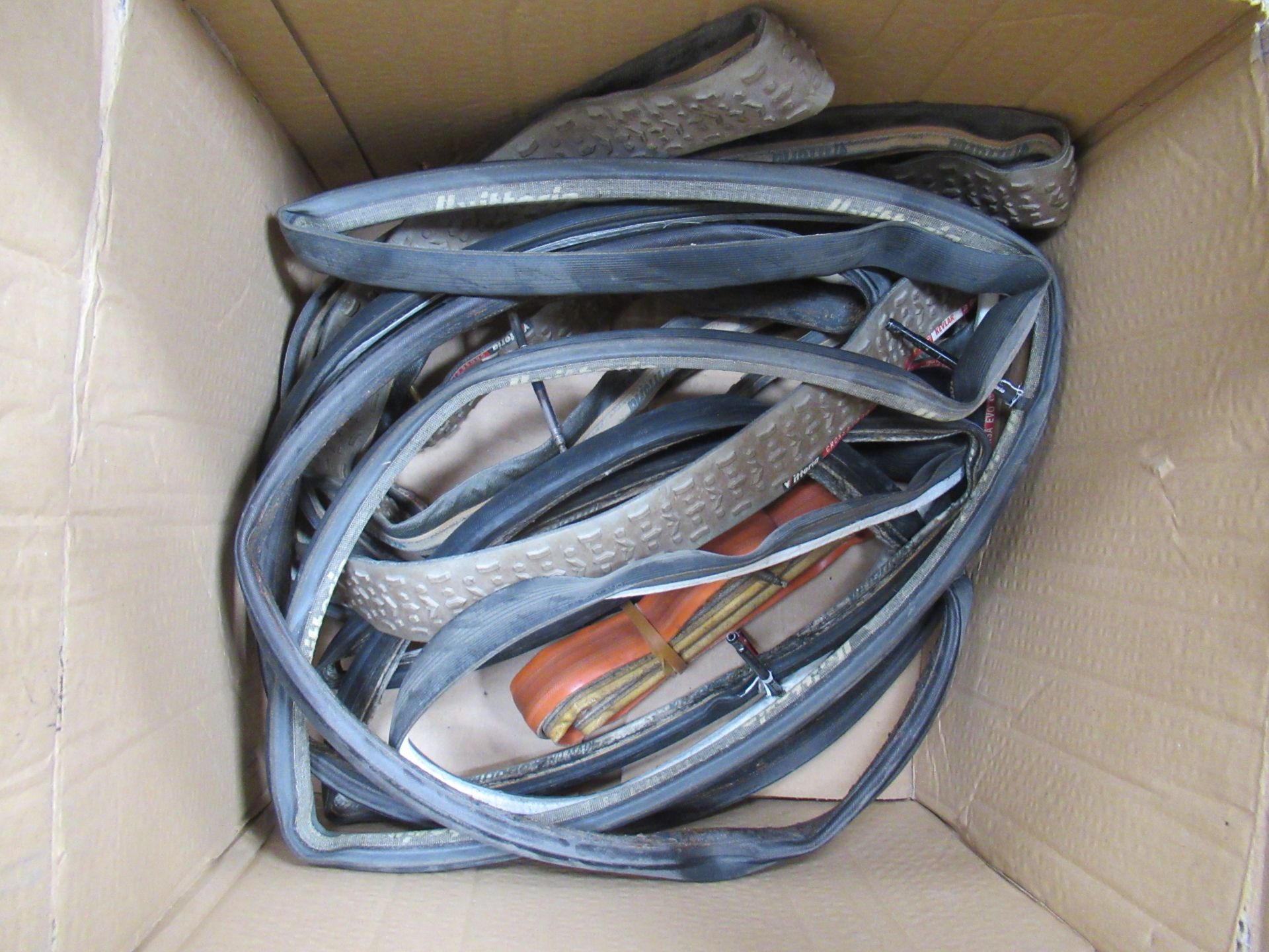 Contents of box including used bicycle tubular tyres