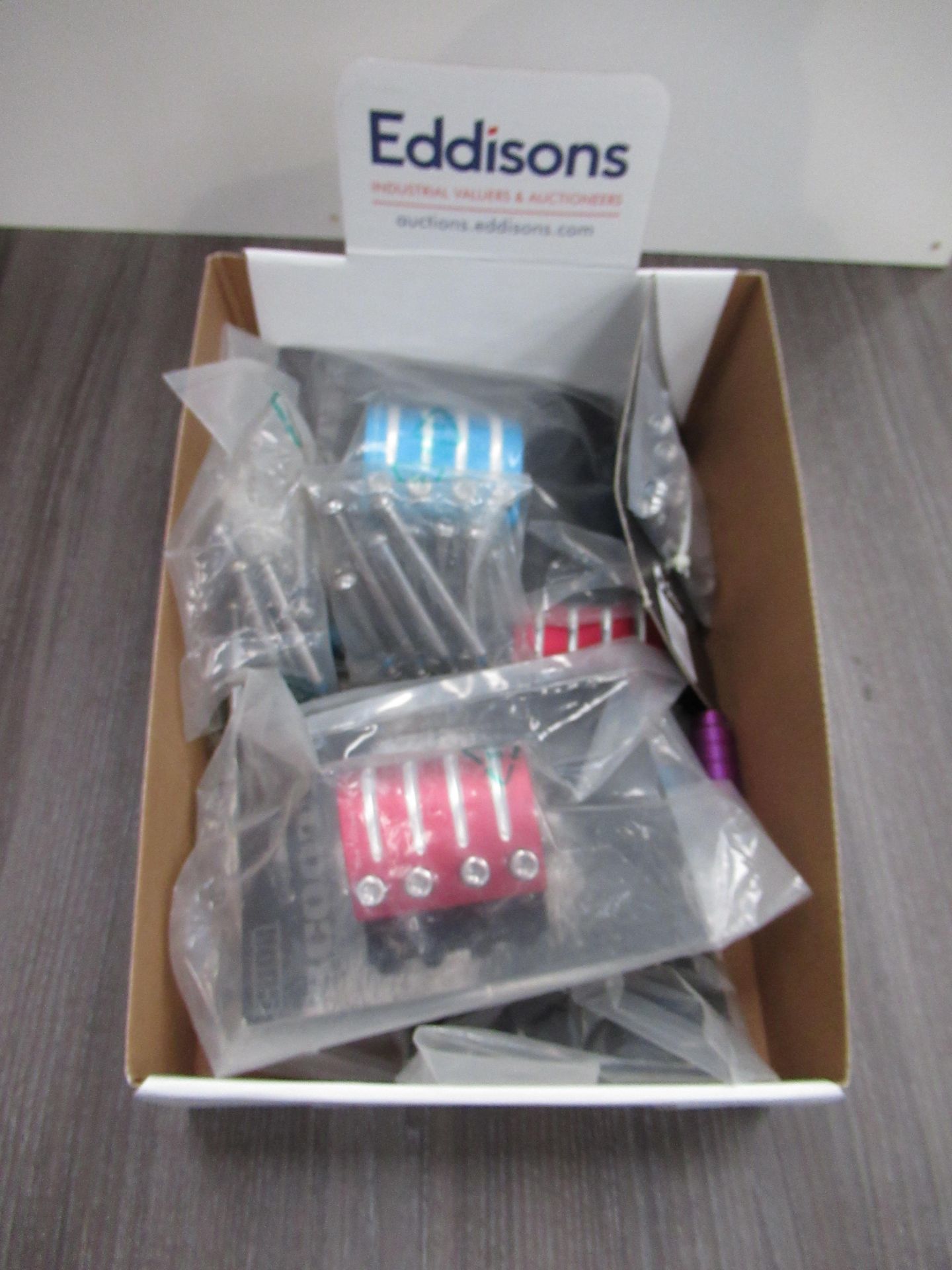 Box of Cuda Scooter's Stunt pegs and CNC clamps - Red, Purple and Blue