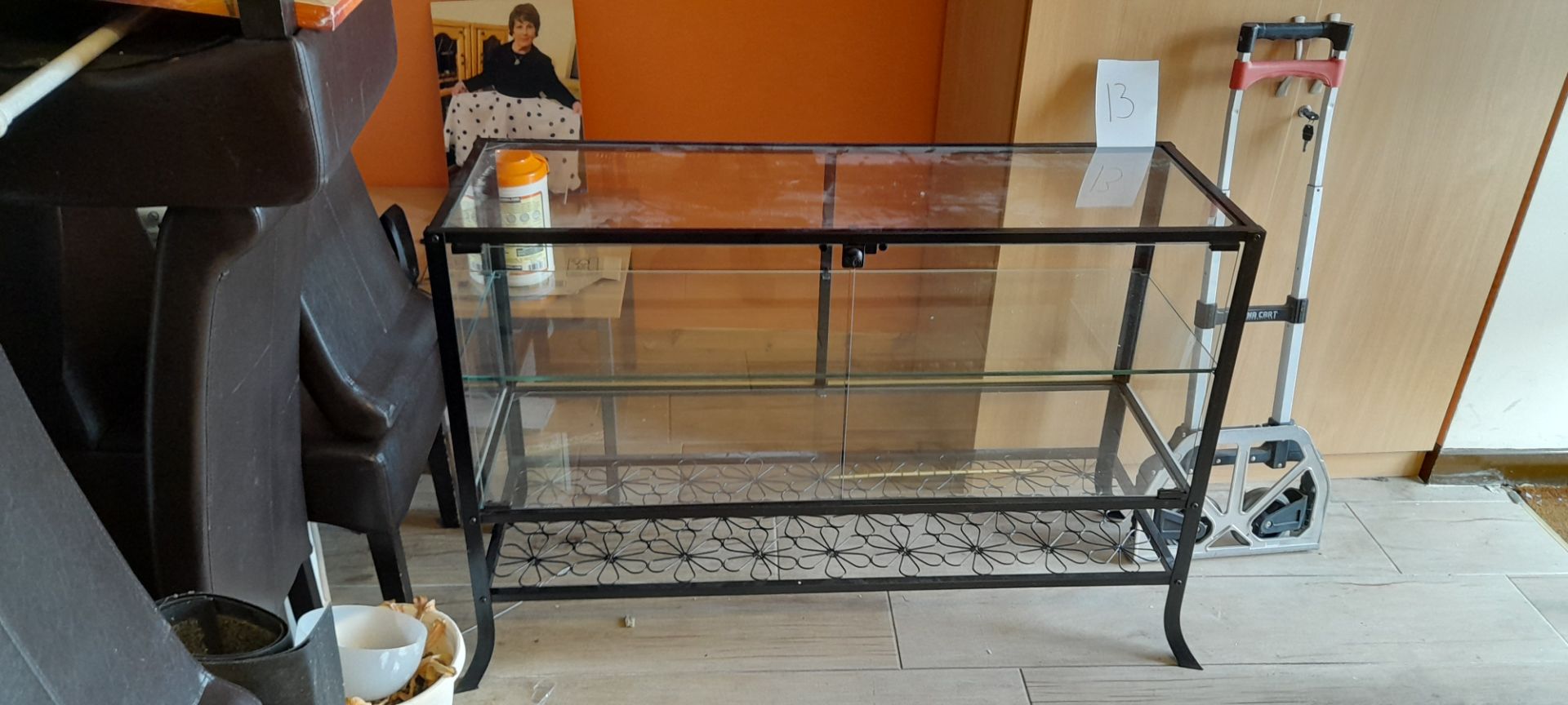 Steel framed glass topped 3 tier display cabinet with floral display on bottom tier 1600 x 400 & 2 x