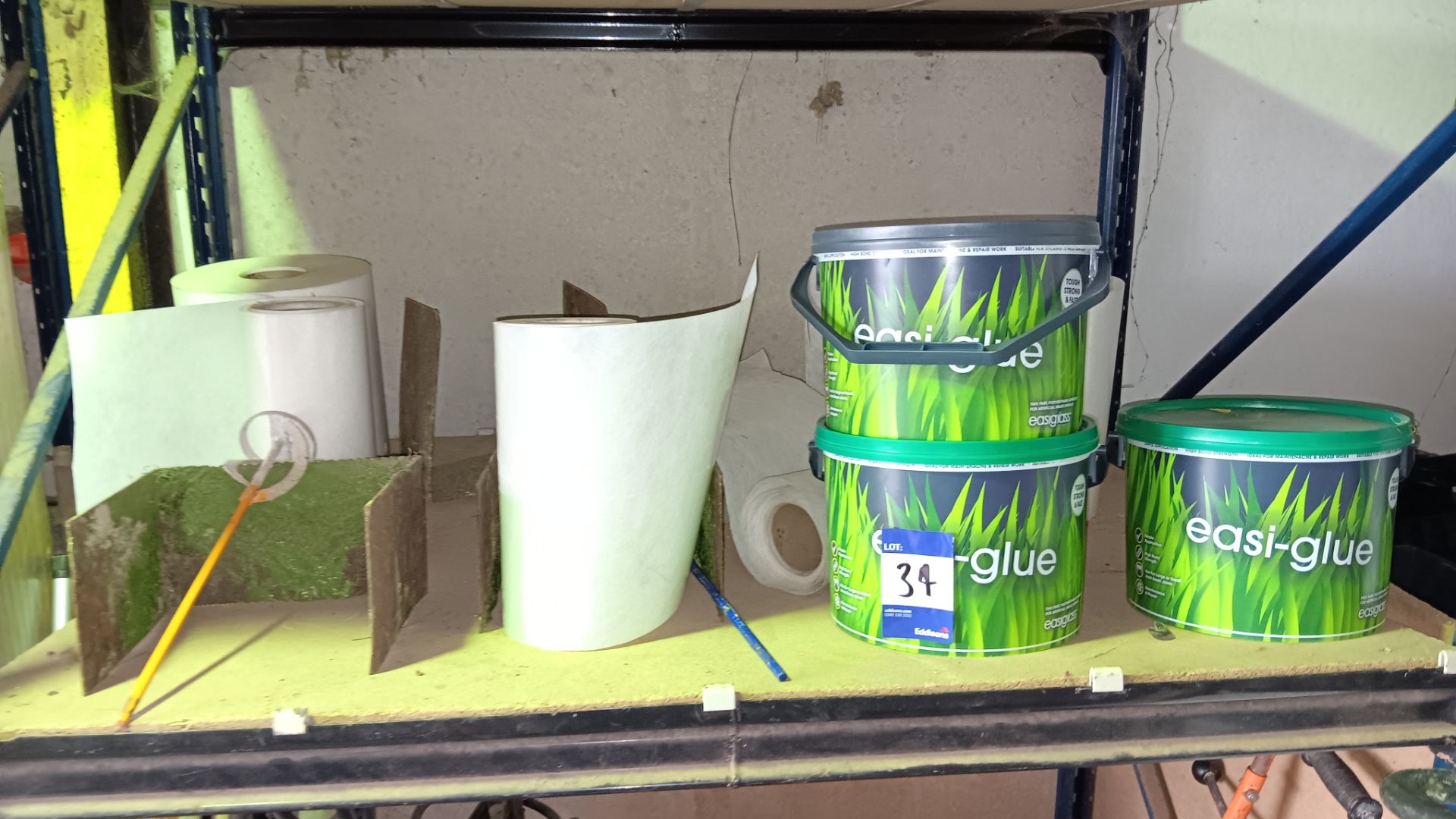 Contents of shelf to include 3 x 5.5kg tubs of Easigrass artificial lawn glue, part rolls of lawn
