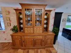 Oak dresser with upper part glazed doors over small drawers and flanked by open fronted shelves, th